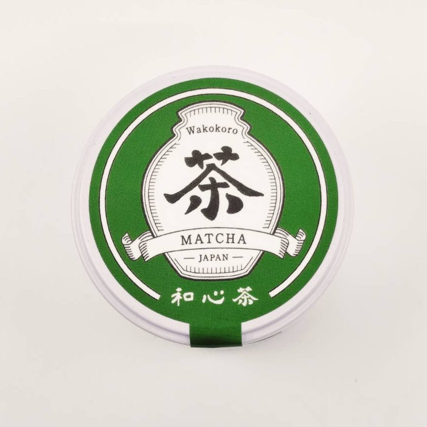 Wakokoro Matcha container with green lid on a white background