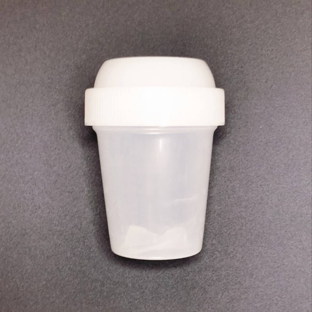 White plastic container with a lid on a gray background
