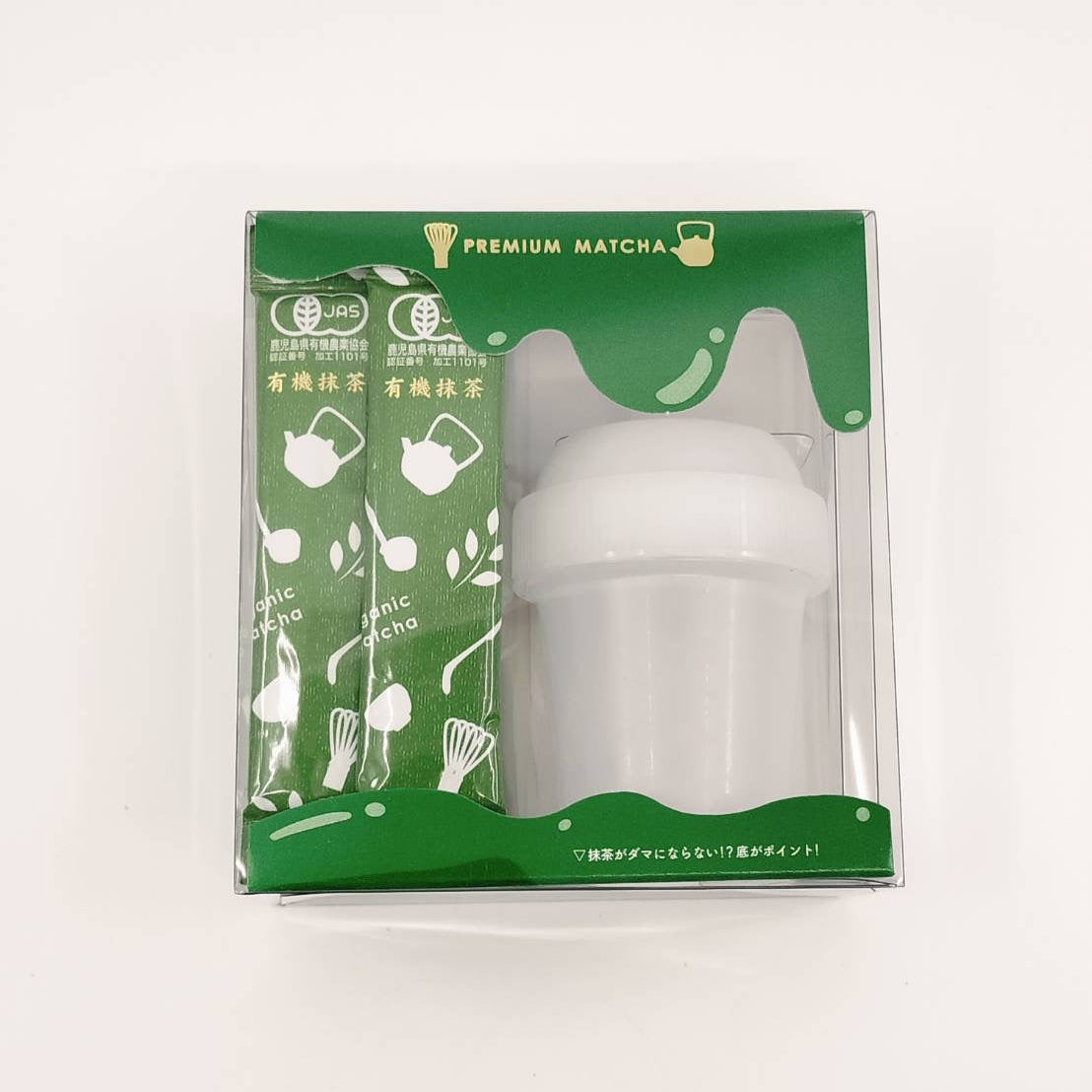 White baby bottle in a green packaging box on a white background