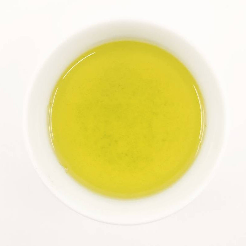 Yellow liquid in a white container on a white background
