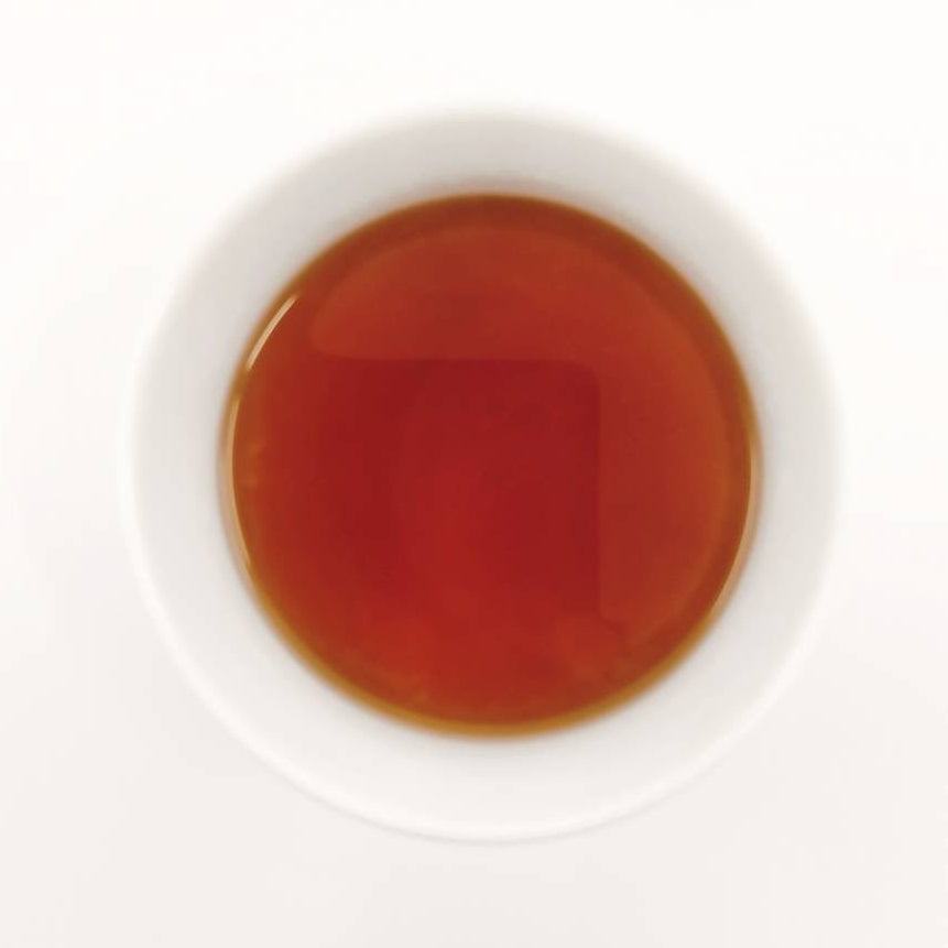 Tea bag in a white cup with a white background