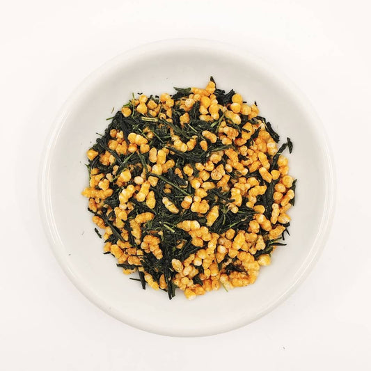 Tea leaves with yellow flowers on a white plate